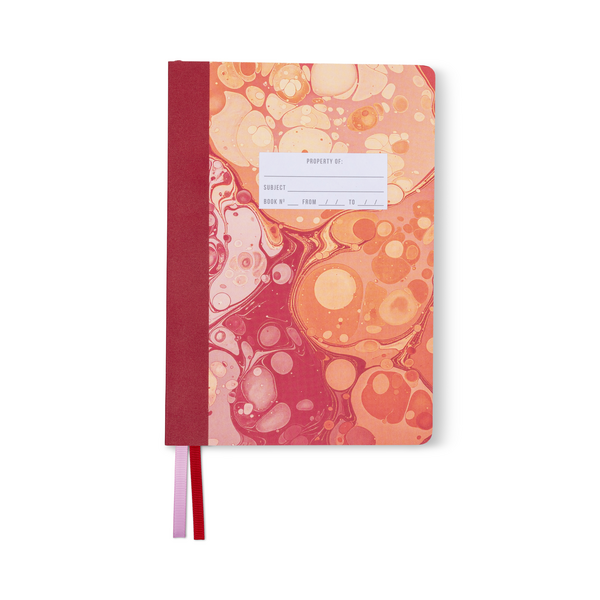 Cover of notebook with pink and orange marbled cover with white label for identifying contents.