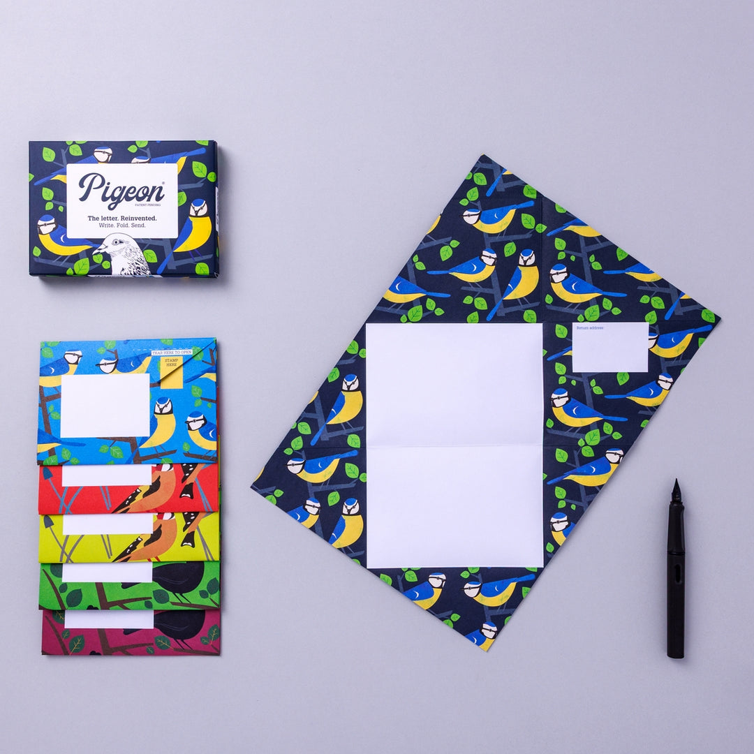 Writing set opened to show five envelopes, each with a different design, and the sixth unfolded to show the writing area, all decorated with bright birds.