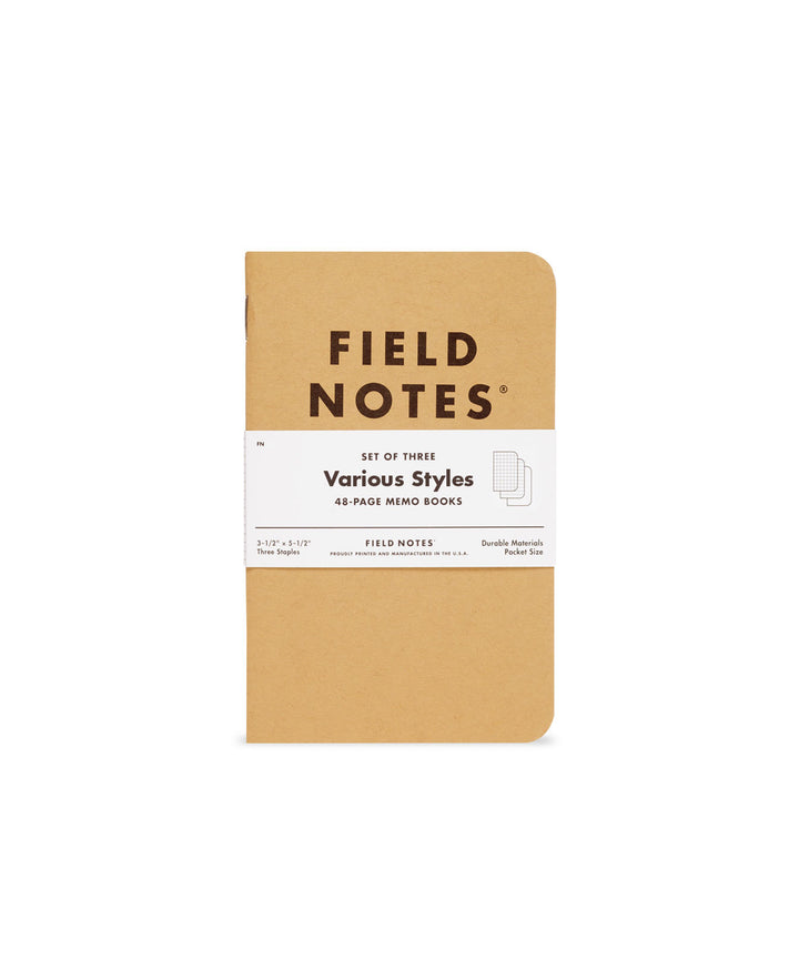 Brown memo book with black text and a white band securing the three notebooks in the set.