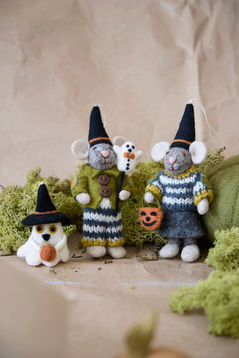 Table scene with the ghost next to two felt mice wearing similar pointed witch's hats and dressed in autumn sweaters.