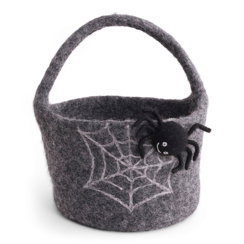 A dark gray felt basket with a spider web and three-dimensional black spider on the side, handmade and suitable for holding treats for Halloween. 