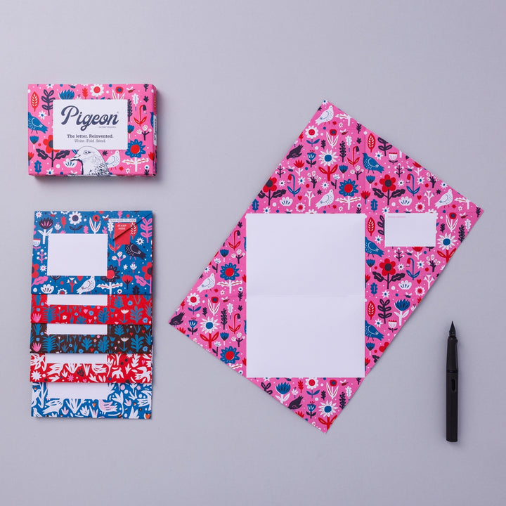 Writing set opened to show five envelopes, each with a different design, and the sixth unfolded to show the writing area, all decorated with bright flowers.