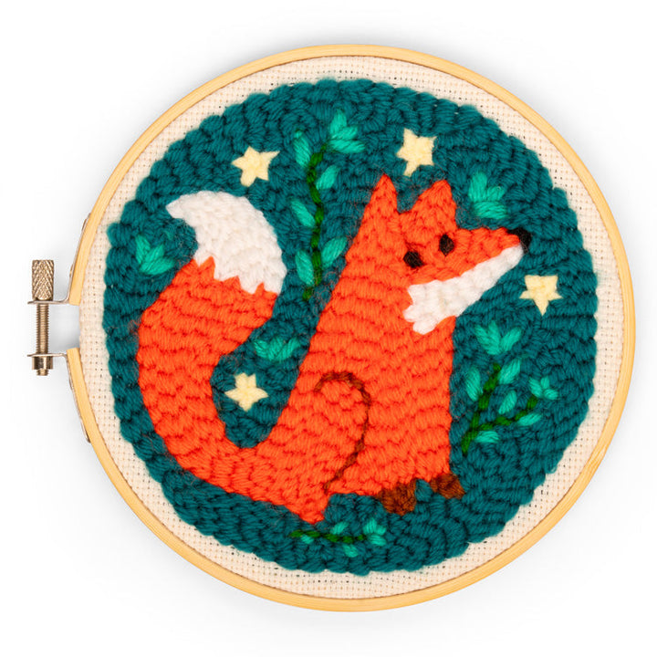 Embroidery hoop with a fox design on a teal background