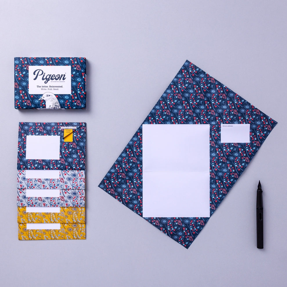 Writing set opened to show five envelopes, each with a different design, and the sixth unfolded to show the writing area, all decorated with flowers.