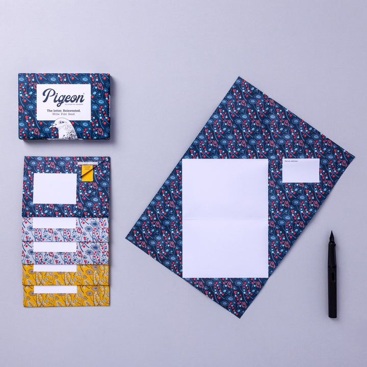 Writing set opened to show five envelopes, each with a different design, and the sixth unfolded to show the writing area, all decorated with flowers.