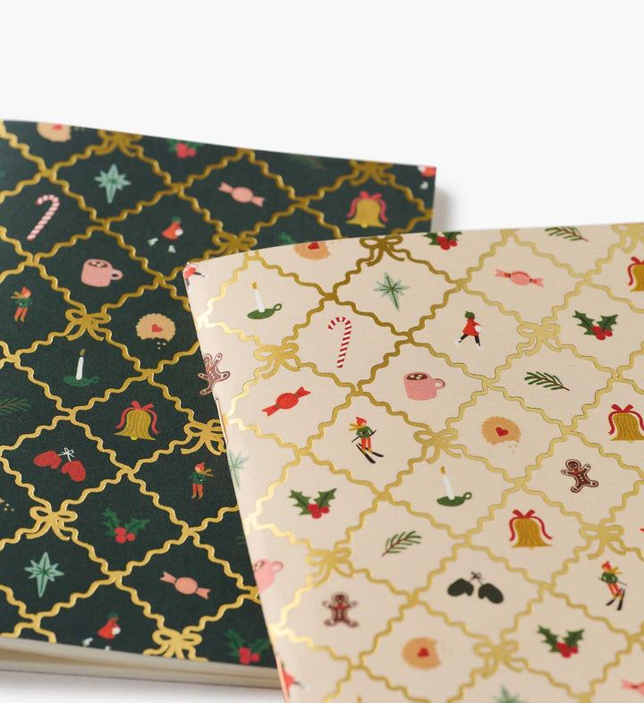 Close up of the pattern on the covers showing images like holly, gingerbread man, mittens and other holiday symbols.