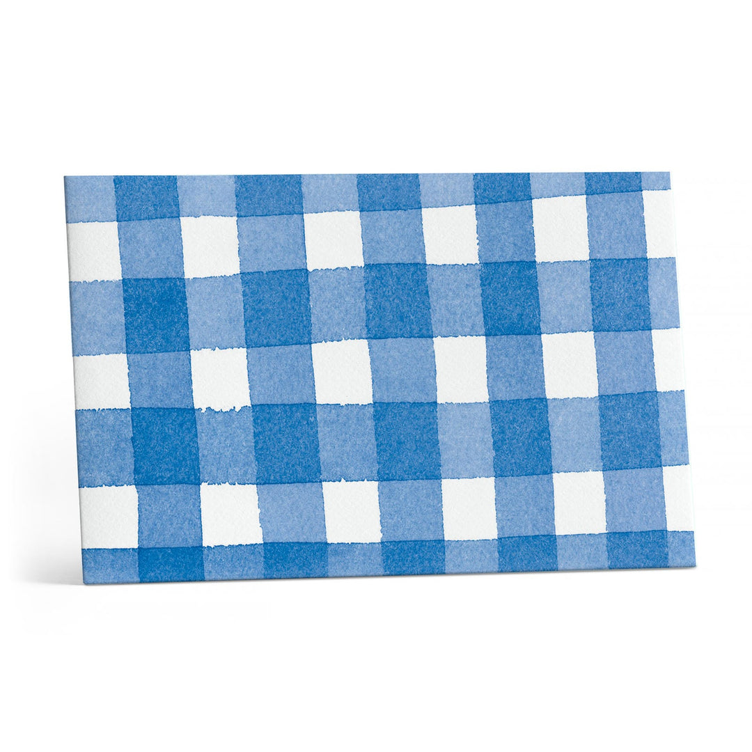 Close up of blue and white checked envelope.