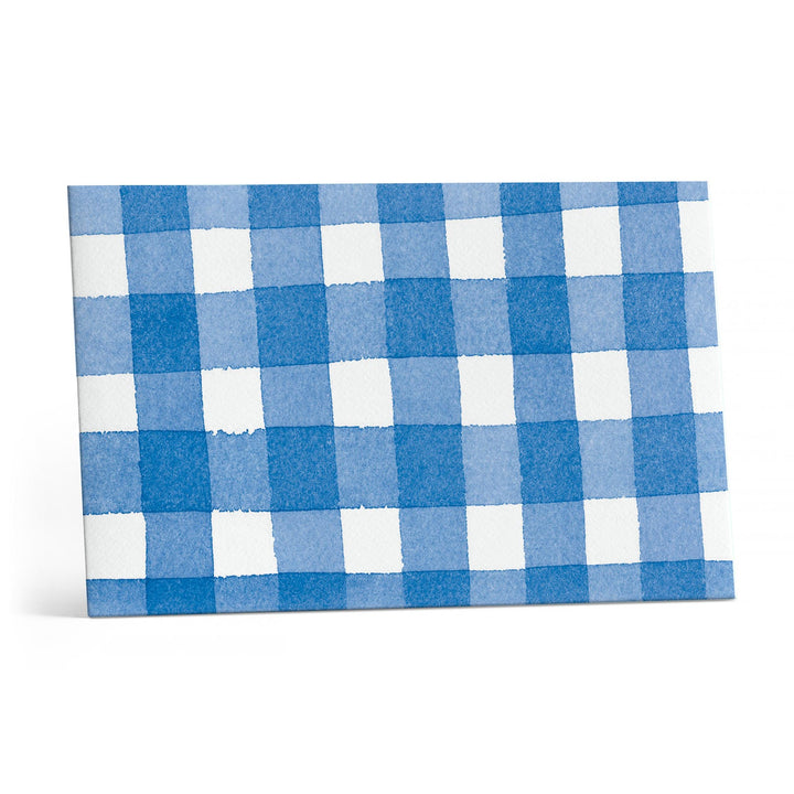Close up of blue and white checked envelope.