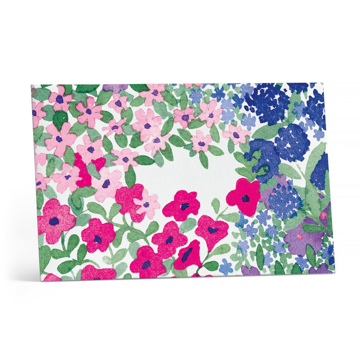 Close up of the envelope with blue, red and pink flowers and an open space in the center.