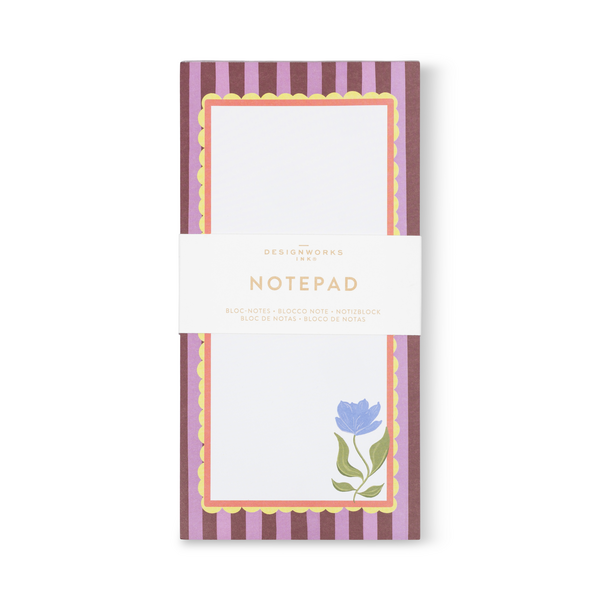 Narrow notepad with purple and brown border and illustration of a blue magnolia in the lower right corner.