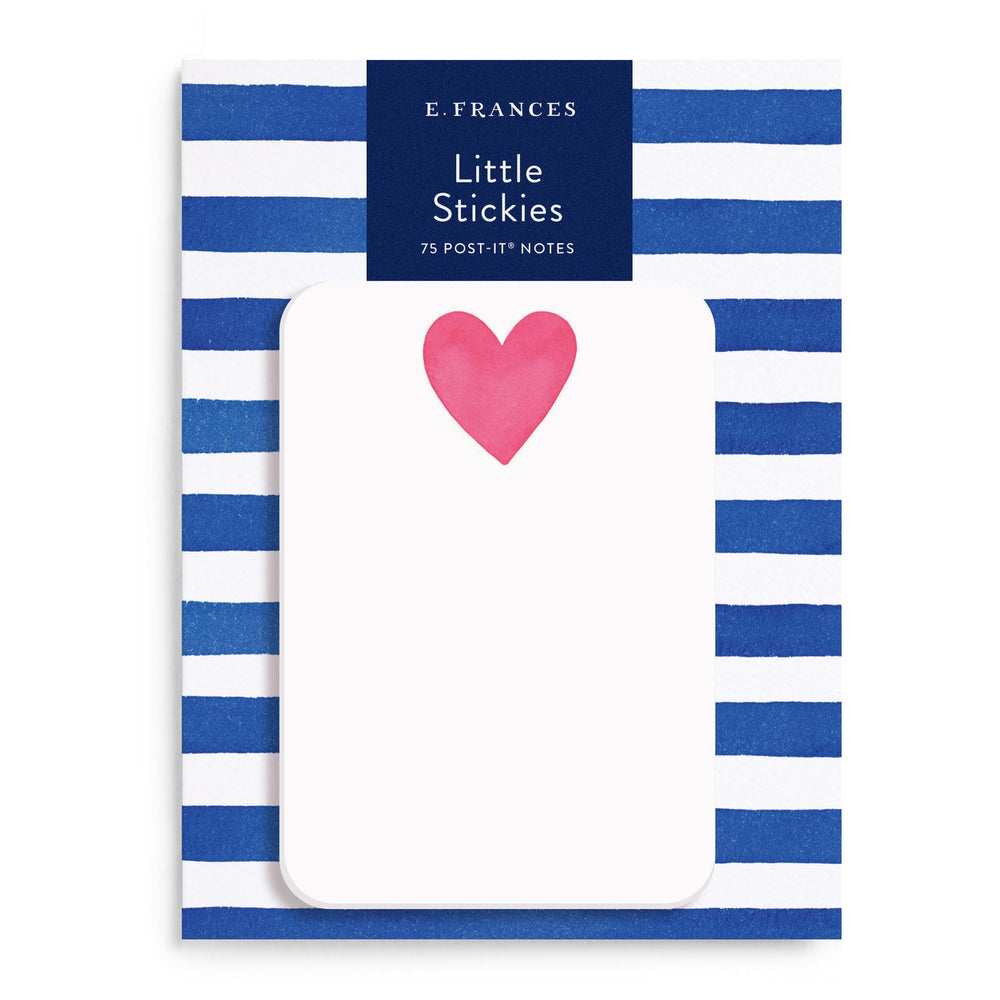 White post-it notes with a red heart at center top, on a blue and white striped package.