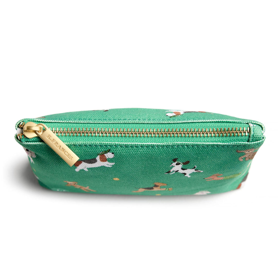 Top of green pouch with images of dogs and a gold zipper across the top.