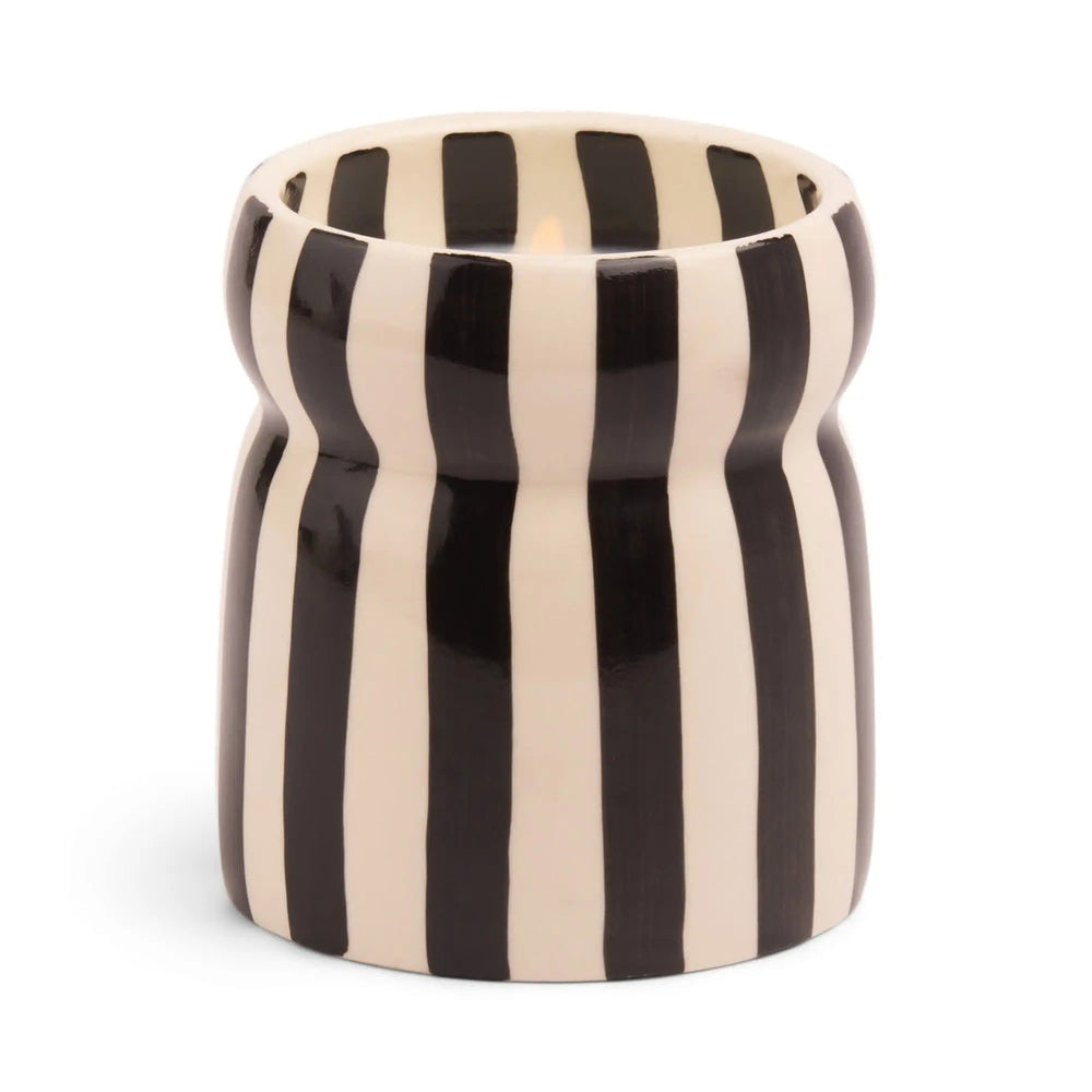 Ceramic candle holder with black and off white vertical stripes.
