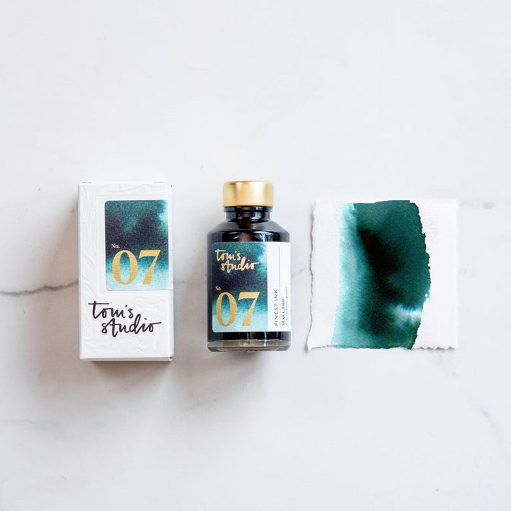 The box of Tom's Studio 07 Mallard Ink next to its bottle and a paint swatch.