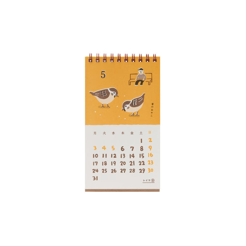Calendar page for May with an illustration of two birds pecking at seeds and a man on a bench on a mustard-colored background.