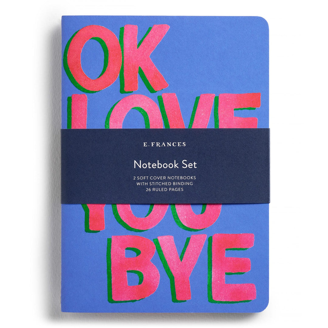 Blue notebook with text in large red letters and a belly band.