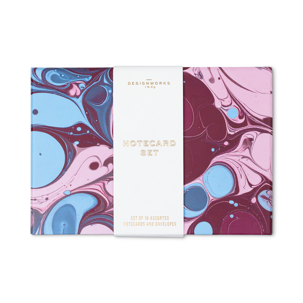 Notecard set with burgundy, blue, and pink marbled design and a packaging band.