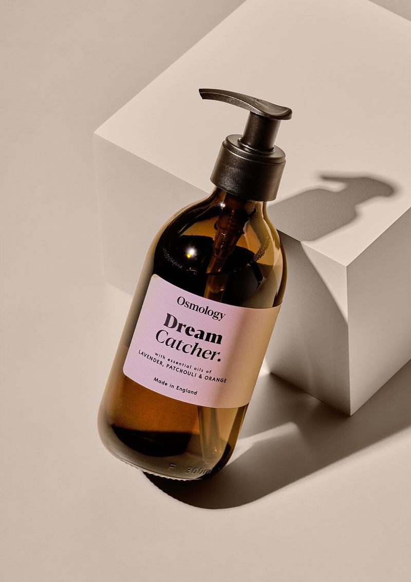 Hand wash in brown glass bottle with pump and light pink label.