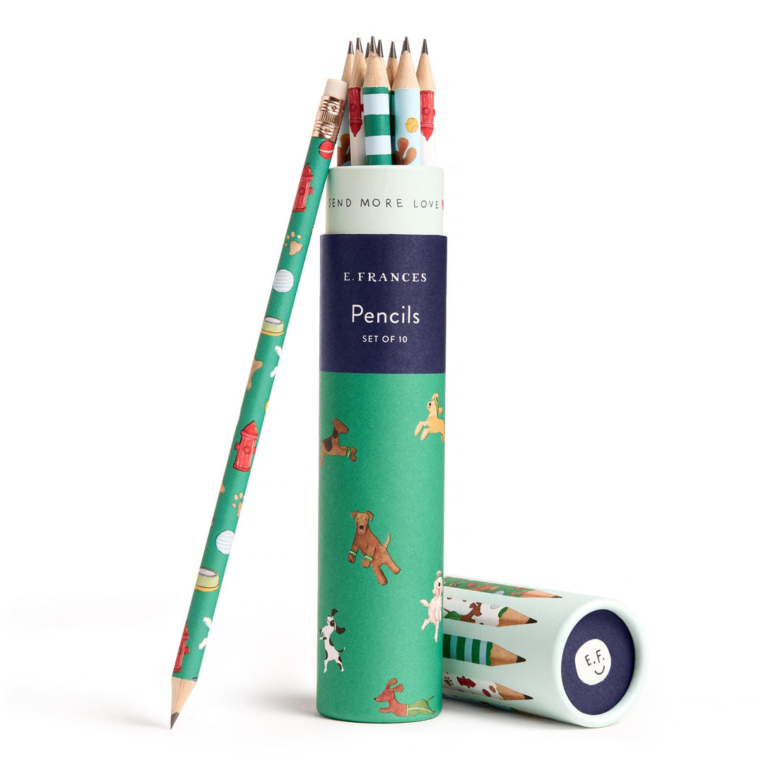 Open round container of pencils decorated with various types of dogs and a single pencil leaning against the container.