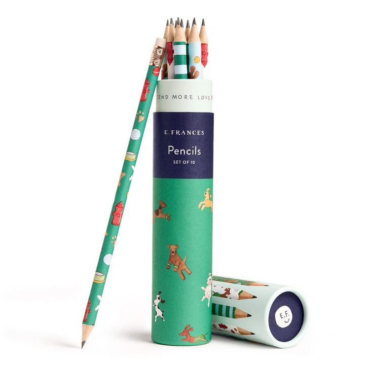 Open round container of pencils decorated with various types of dogs and a single pencil leaning against the container.