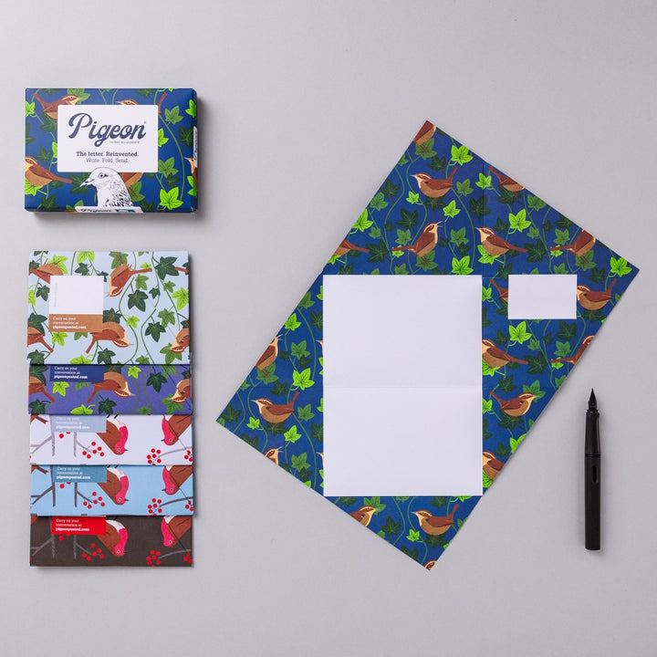 Writing set opened to show five envelopes, each with a different design, and the sixth unfolded to show the writing area, all decorated with birds and leaves.