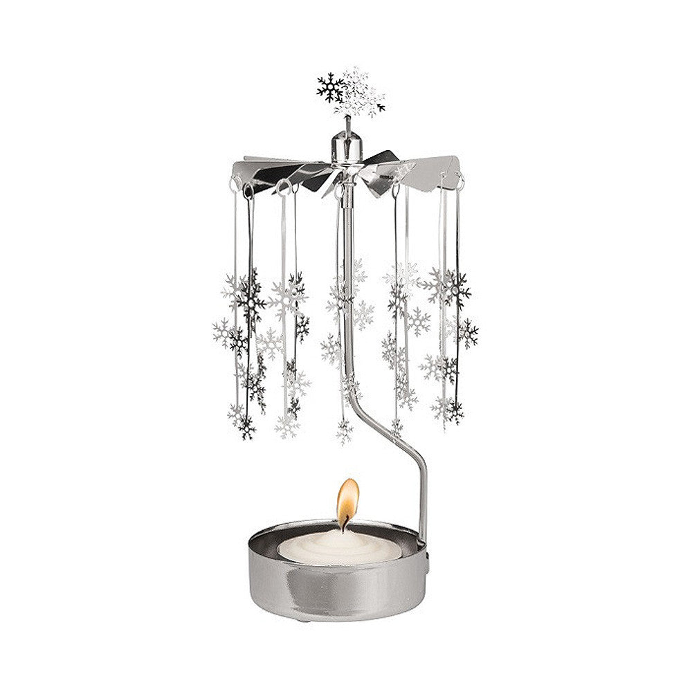 Tea light in a silver holder with vertical arm supporting a carousel of snowflakes.