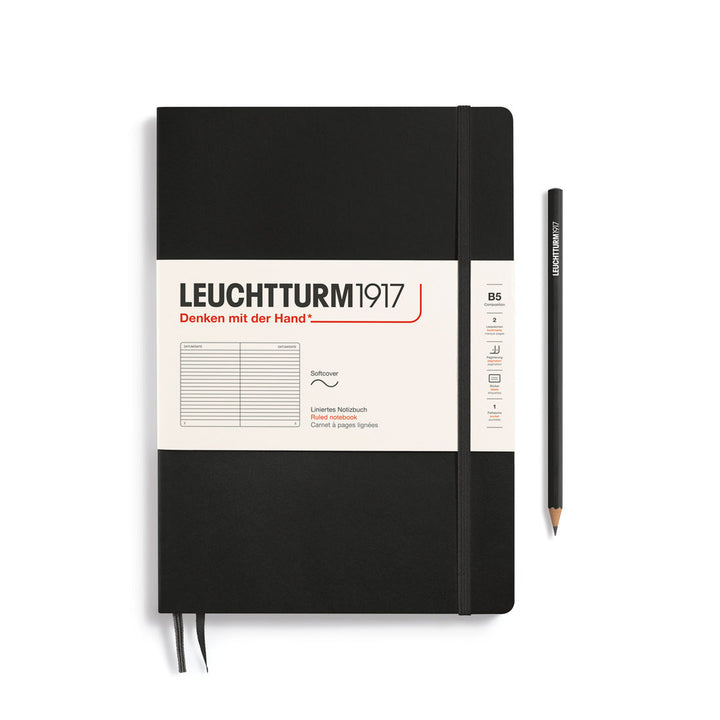 Leuchtturm1917 soft cover ruled page notebook in black with white label and elastic closure, next to a black Leuchtturm1917 pencil.