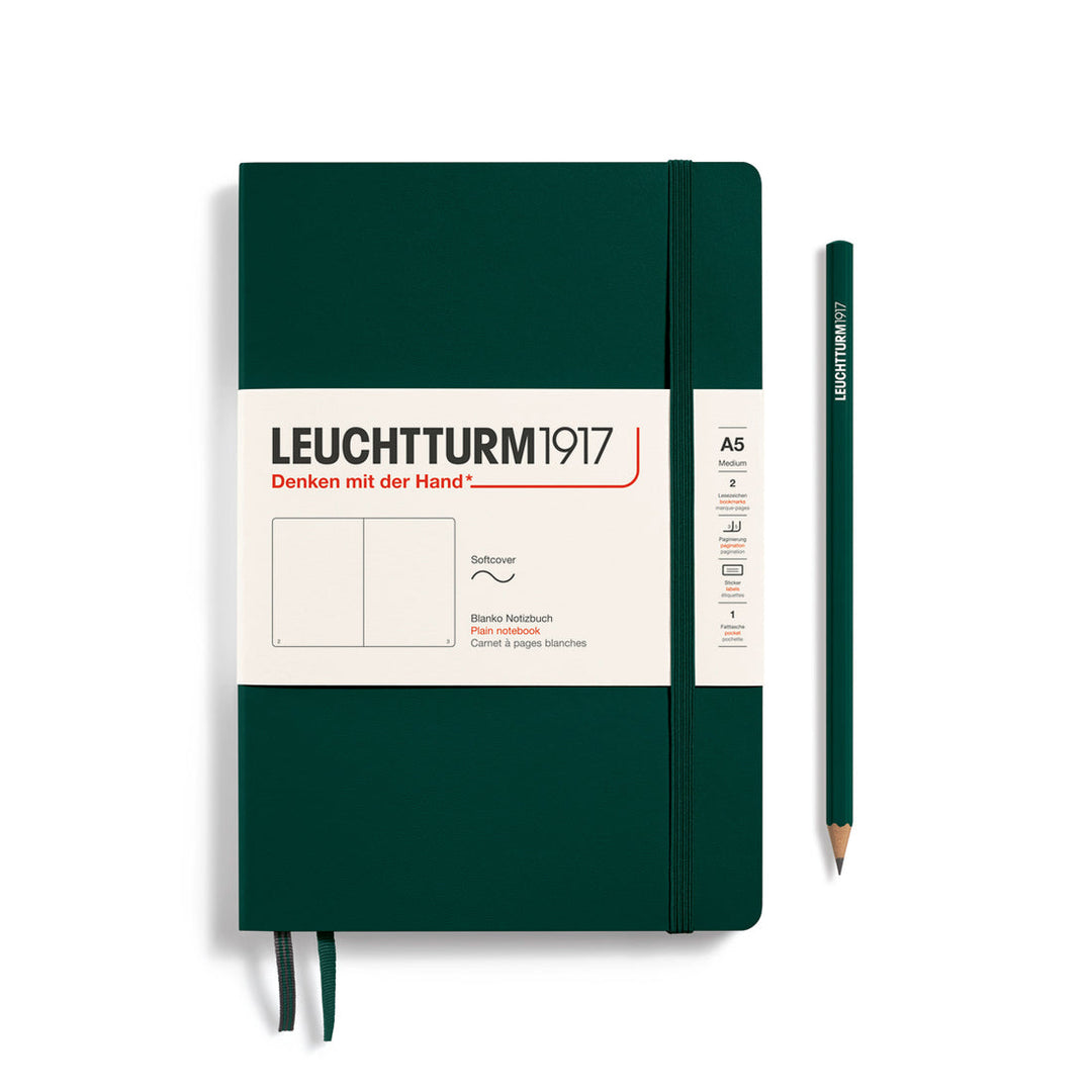 Leuchtturm1917 soft cover ruled page notebook in forest green with white label and elastic closure, next to a forest green Leuchtturm1917 pencil.