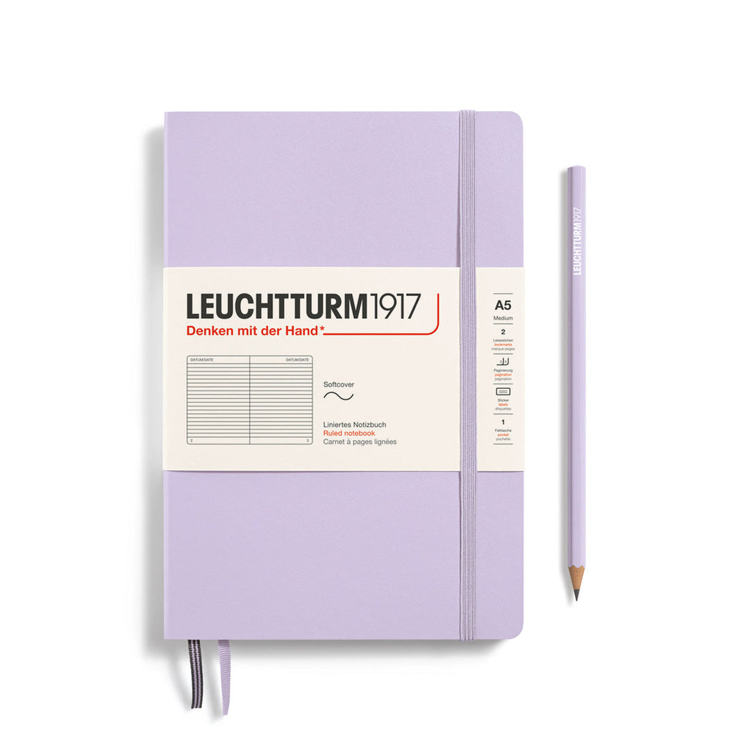 Leuchtturm1917 soft cover ruled page notebook in lilac with white label and elastic closure, next to a lilac Leuchtturm1917 pencil.
