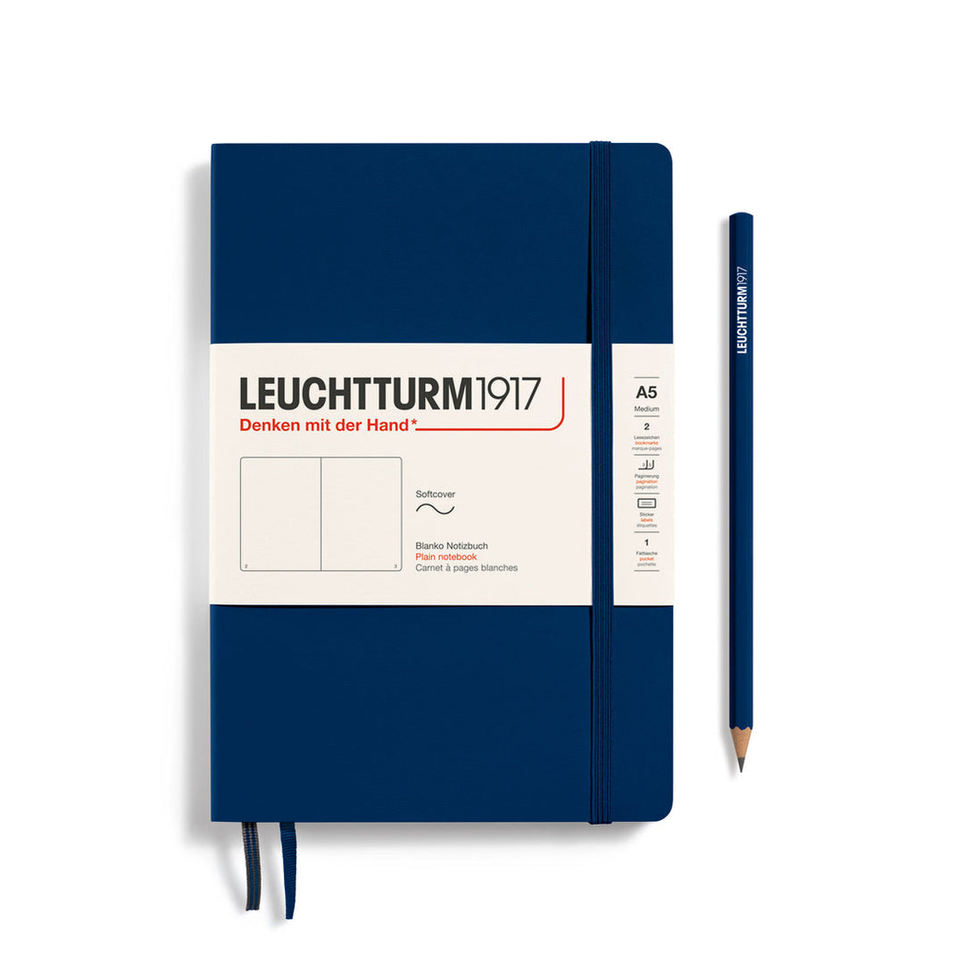 Leuchtturm1917 soft cover plain page notebook in navy blue with white label and elastic closure, next to a navy Leuchtturm1917 pencil.