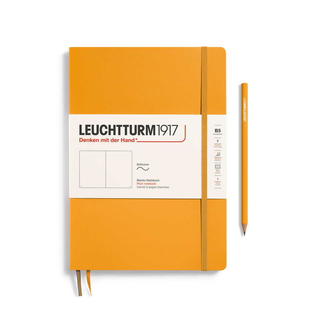Leuchtturm1917 soft cover plain page notebook in rising sun orange with white label and elastic closure, next to an orange Leuchtturm1917 pencil.