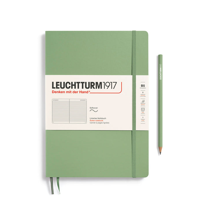 Leuchtturm1917 soft cover ruled page notebook in sage green with white label and elastic closure, next to sage green Leuchtturm1917 pencil.