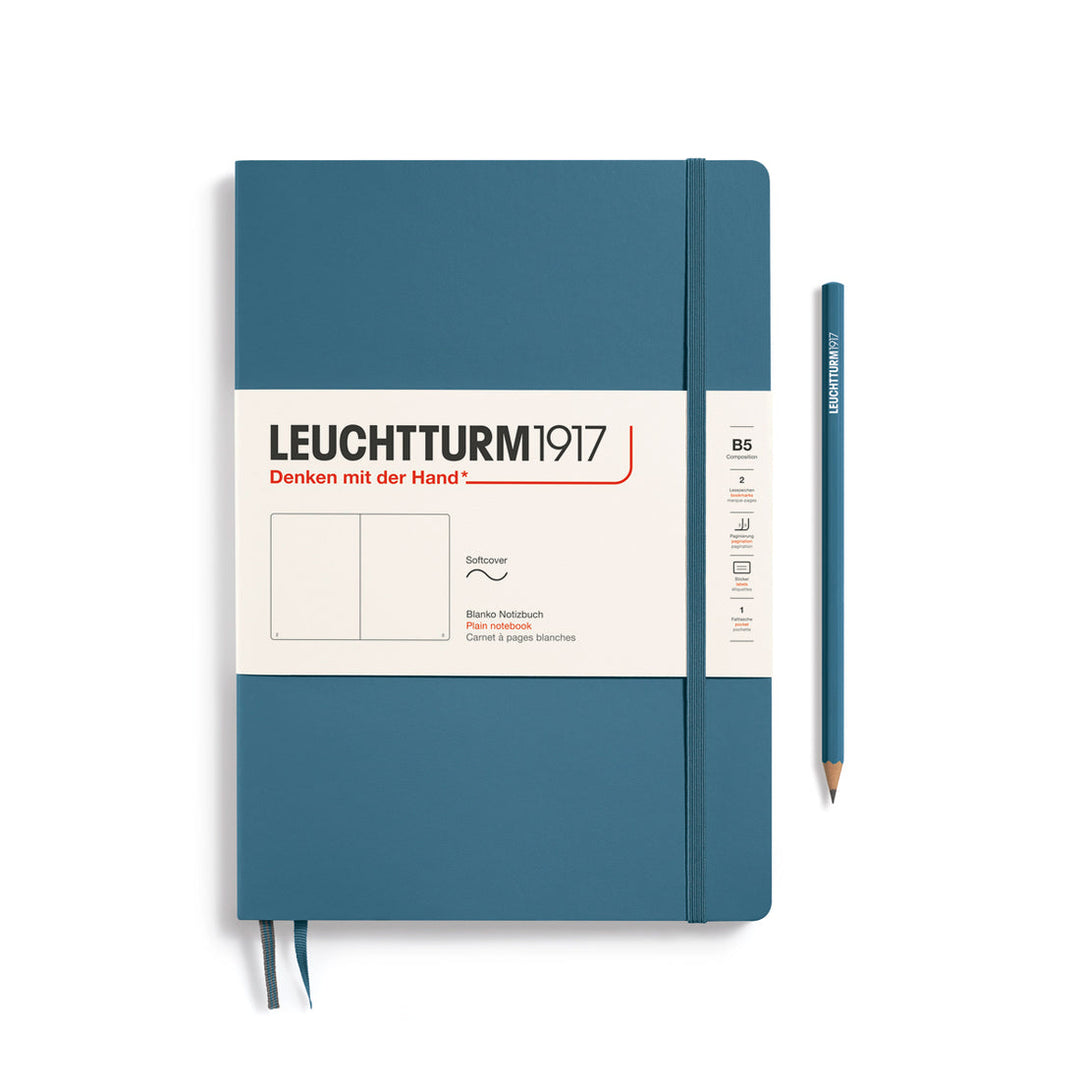Leuchtturm1917 soft cover plain page notebook in stone blue with white label and elastic closure, next to a stone blue Leuchtturm1917 pencil.