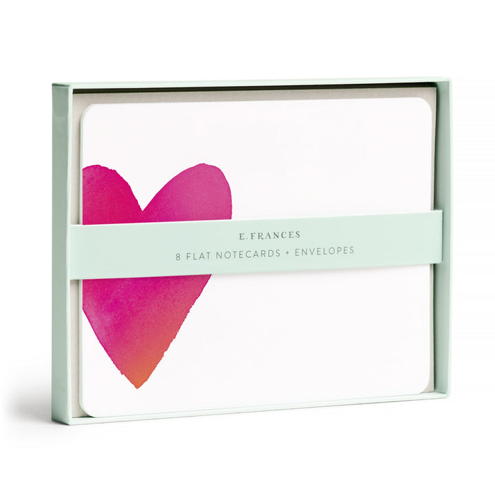 Box of cards with belly band, with large red heart on the left of a white card.