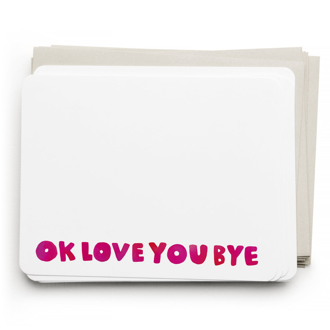 Stack of white cards, with hand-drawn "OK LOVE YOU BYE" in red across the bottom, atop light gray envelopes.