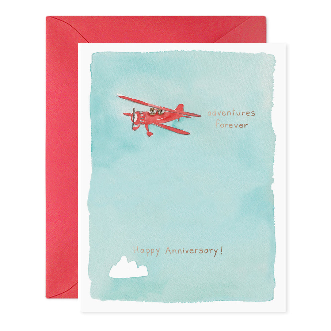 Greeting card with red airplane and 'Happy Anniversary!' text on a light blue background, with a red envelope.