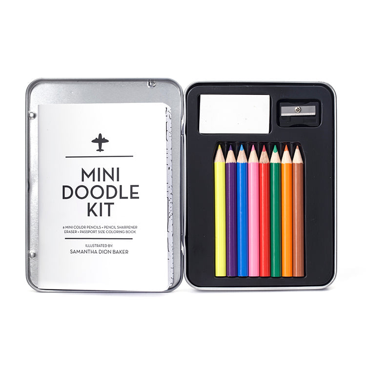 Opened tin of 8 colored pencils, with pad of paper, pencil sharpener, and instruction booklet.