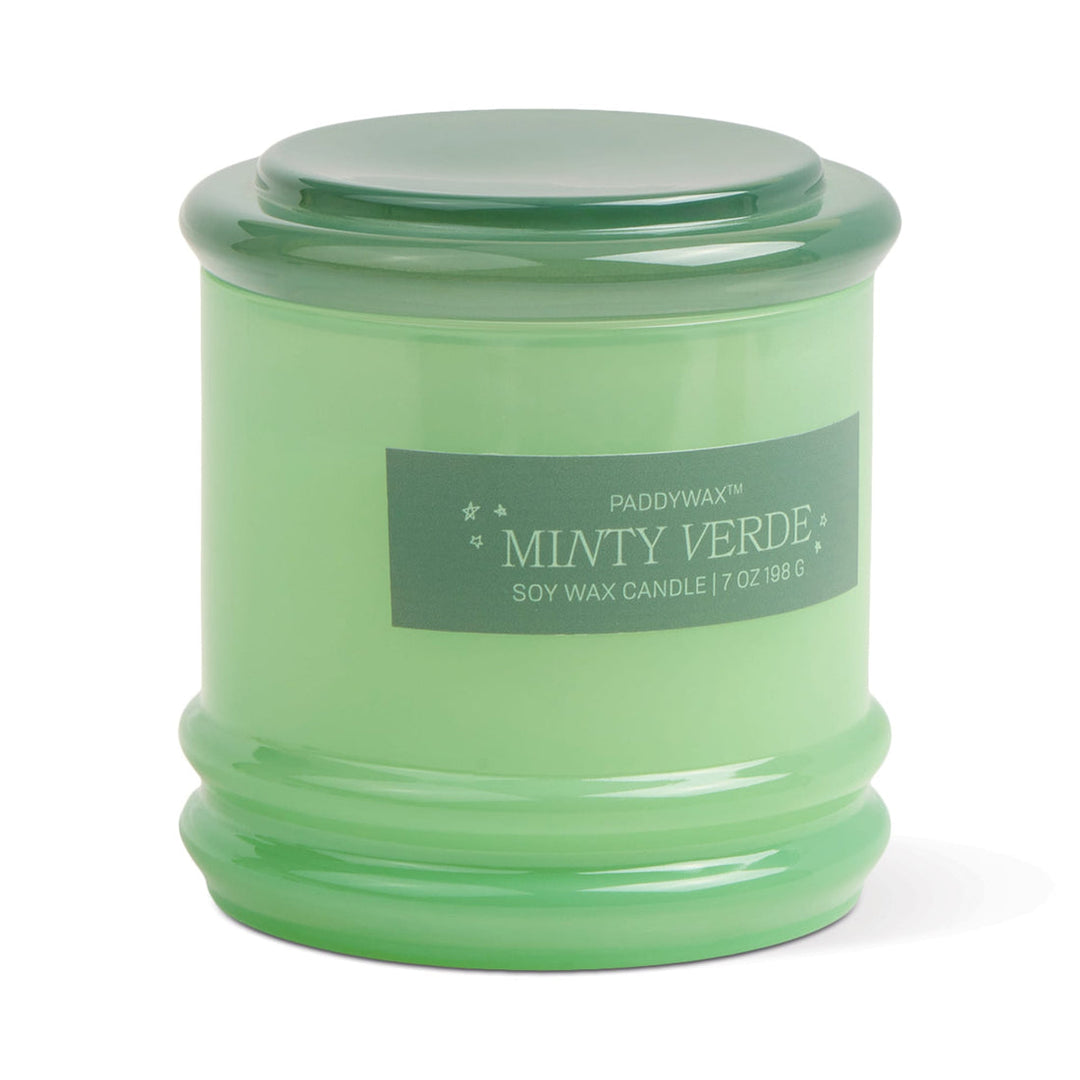 Glass container for candle with light green body and dark green lid.