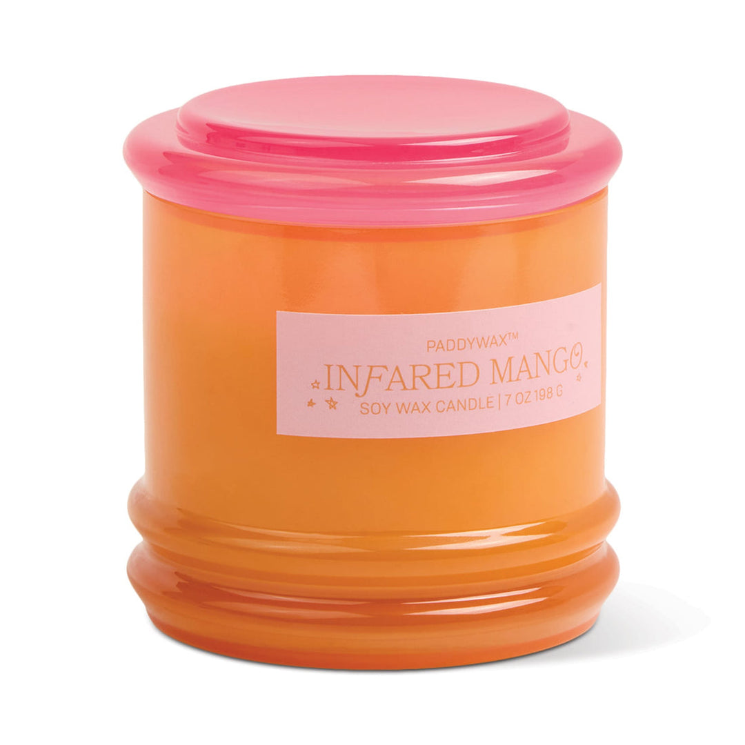 Glass container for candle with orange body and pink lid.
