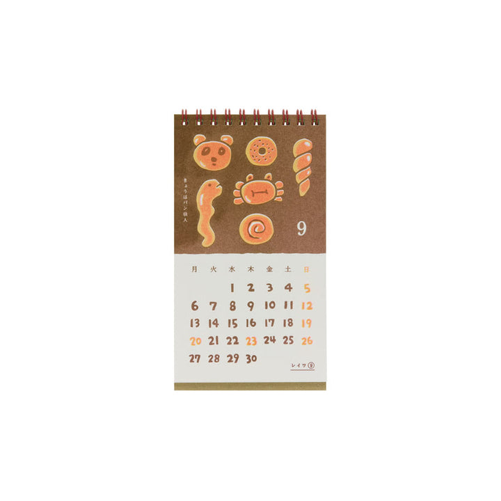 Calendar page for September with an illustration of breads in various fun shapes.