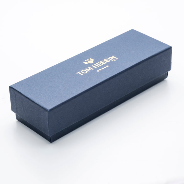Closed Tom Hessin blue gift box.