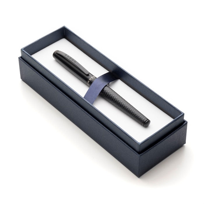 Black pen in an open gift box.