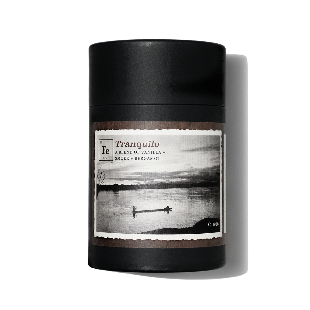 Gift box for Iron Collective candle. Tranquilo label has image of canoers on a still lake.