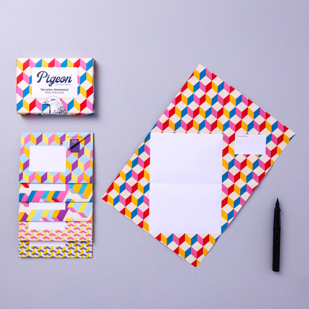 Writing set opened to show five envelopes, each with a different design, and the sixth unfolded to show the writing area, all decorated with geometric shapes.