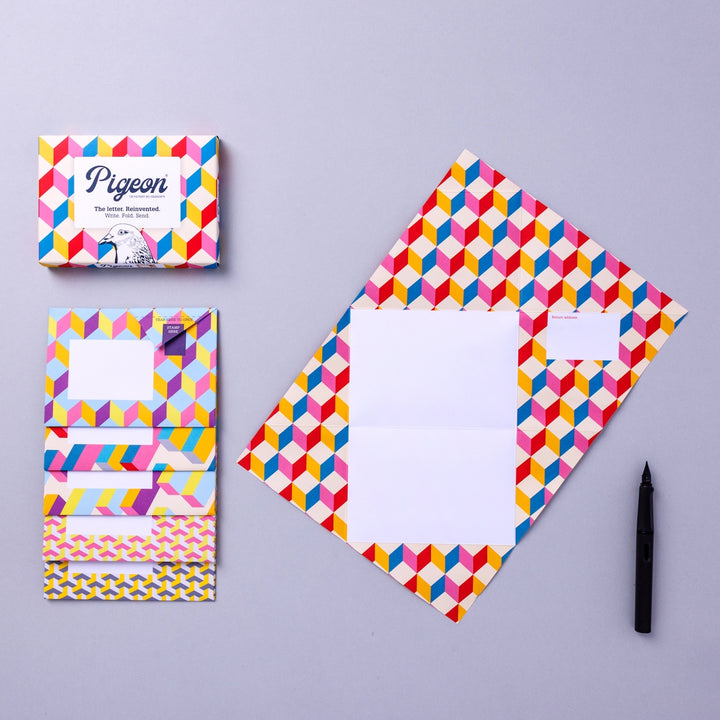Writing set opened to show five envelopes, each with a different design, and the sixth unfolded to show the writing area, all decorated with geometric shapes.
