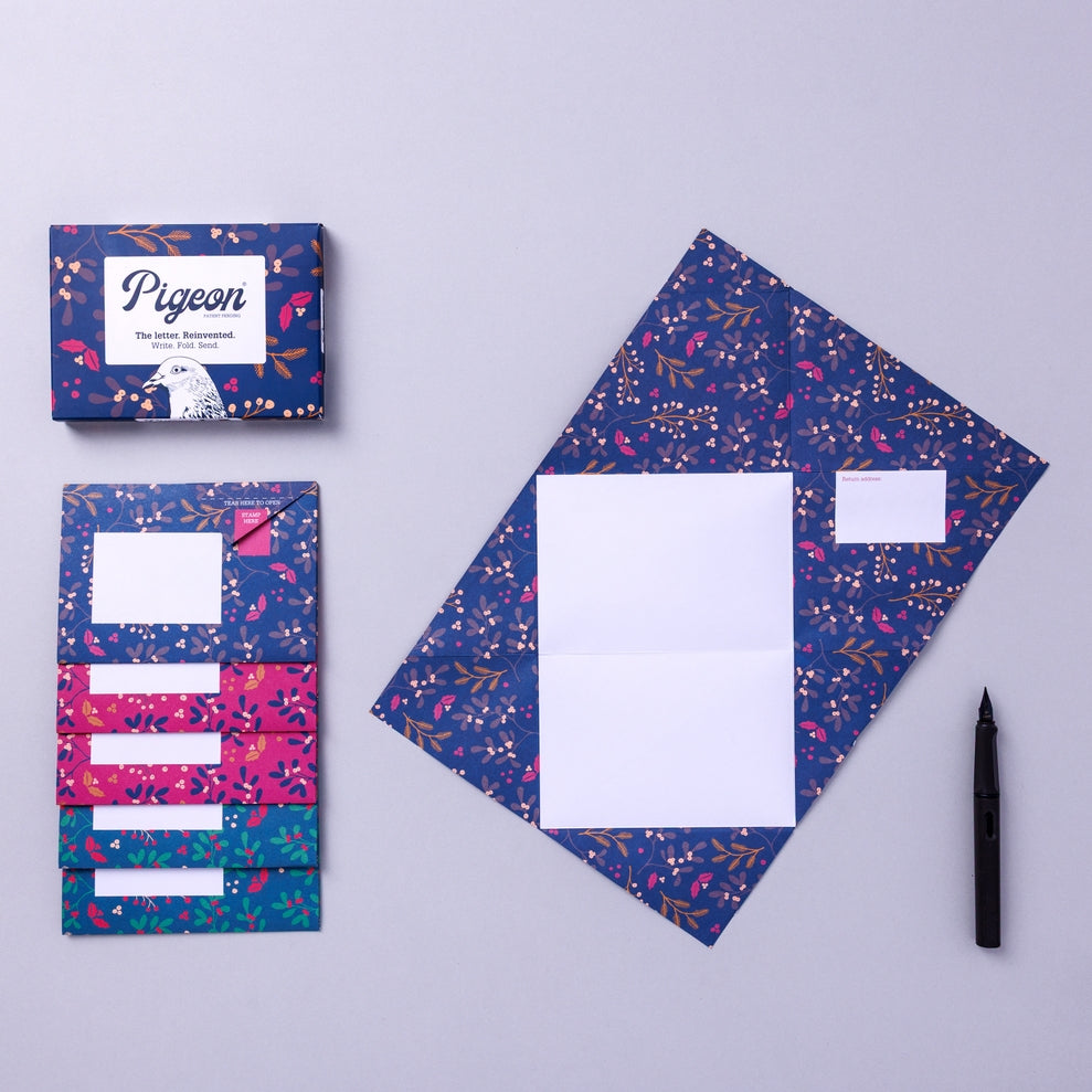 Writing set opened to show five envelopes, each with a different design, and the sixth unfolded to show the writing area, all decorated with flowers.