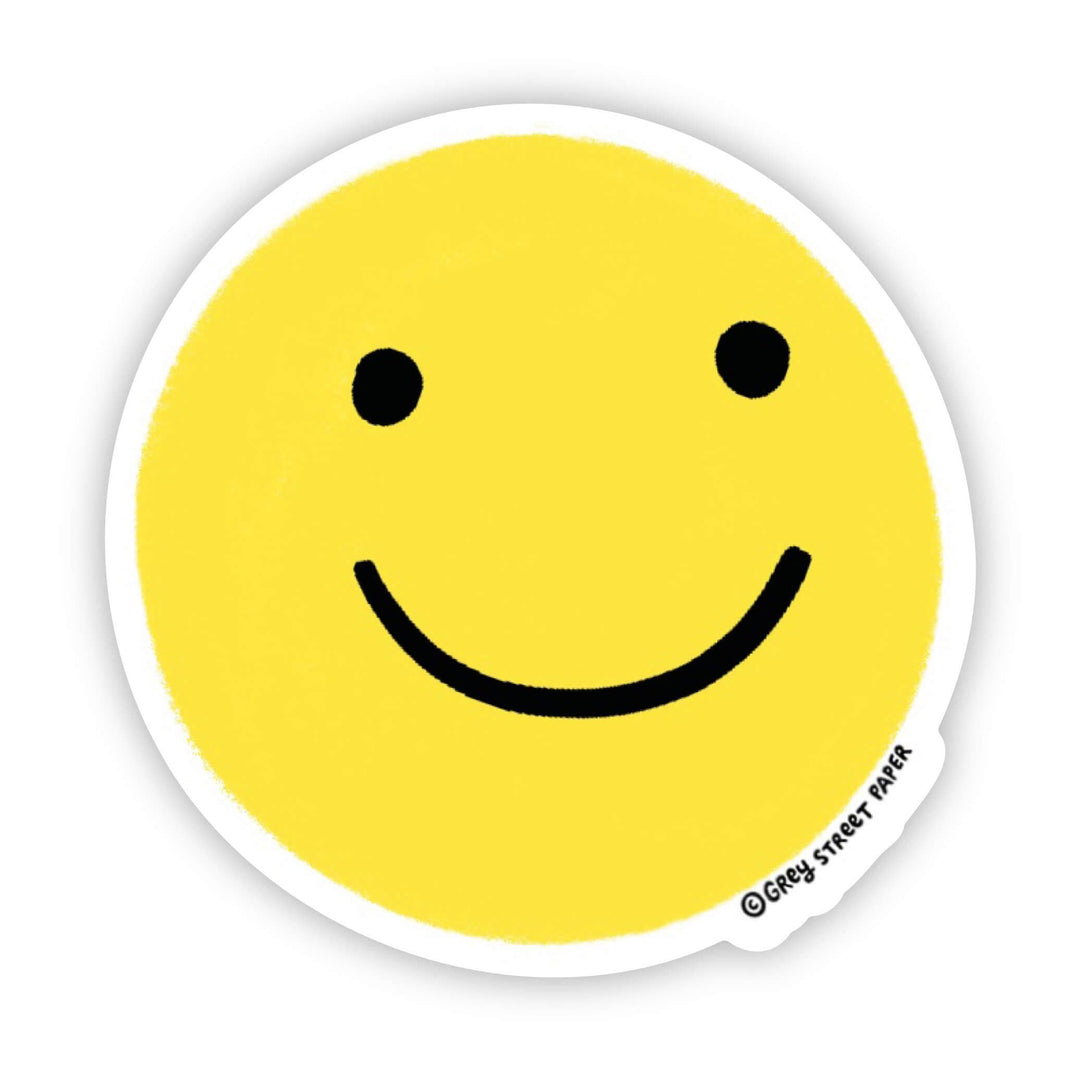 Circular yellow smiley face sticker with black eyes and mouth.