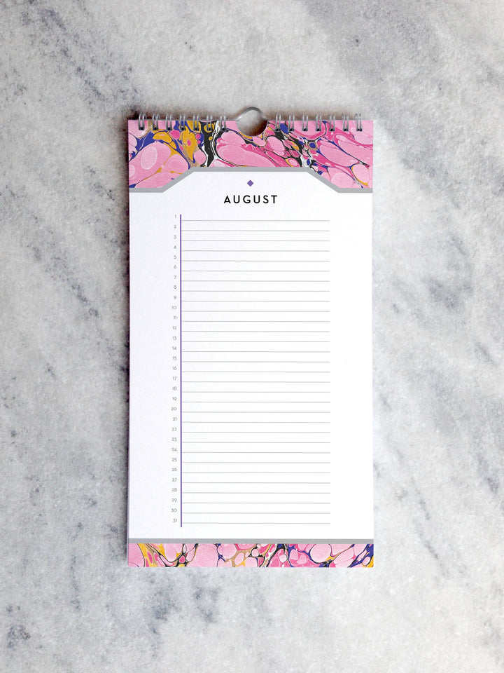 Page for January with marbled paper in shades of pink at the top and bottom. Below the month title is a line for each day of the month.