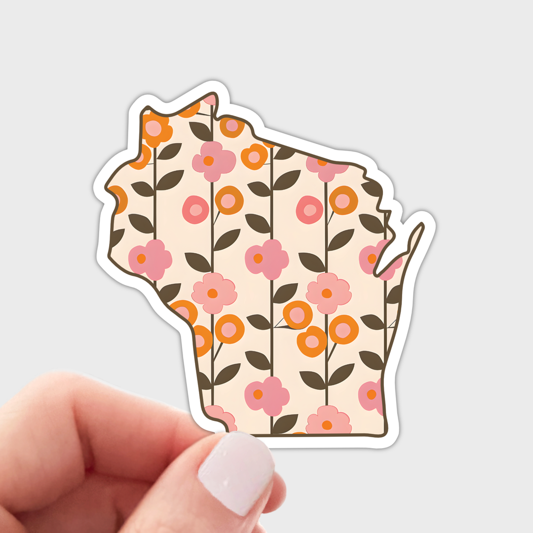 A die-cut sticker shaped like the state of Wisconsin, featuring a retro floral pattern with pink and orange flowers and dark green leaves on a cream background.