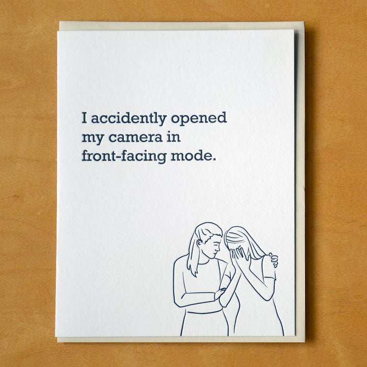 Front of card with a line drawing in black of one woman consoling another.